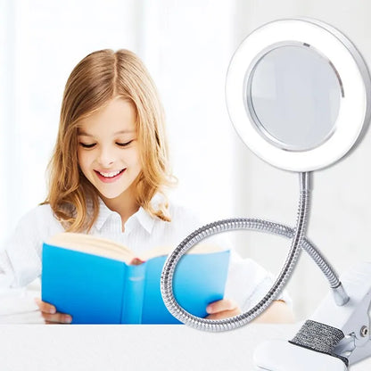 Flexible table lamp with magnifying glass.