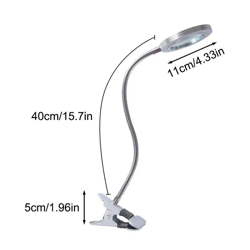 Flexible table lamp with magnifying glass.